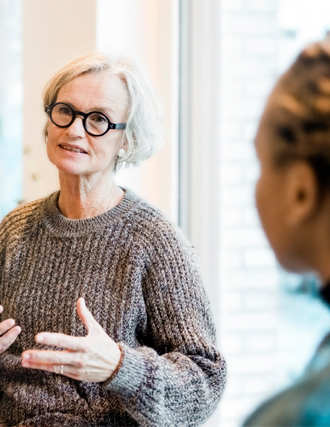 Older woman with glasses attending mental health support session