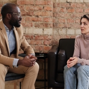 Two people sitting down on sofas holding a conversation busting pychology myths