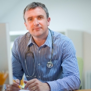 General Practitioner sitting at desk filling out psychology referral