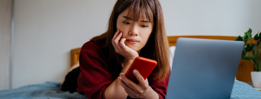 Teenager on bed experiencing cyberbullying