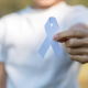 Woman holding white ribbon