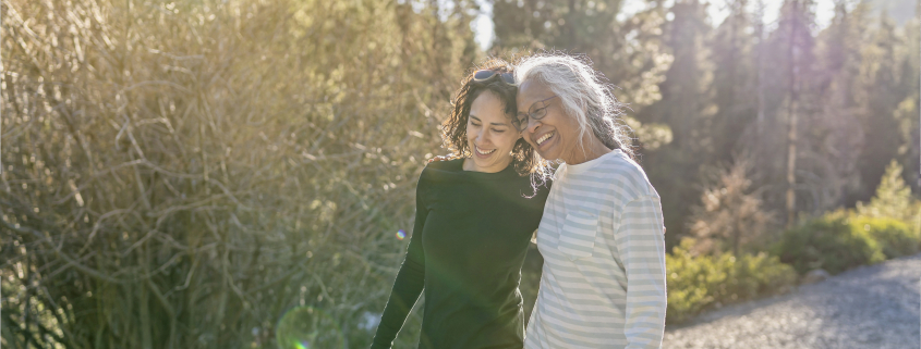 Woman helping her friend with mental health issues at Christmas by taking her on a walk outside