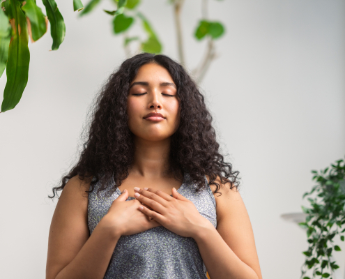 Woman using breathing techniques to control anxious breathing