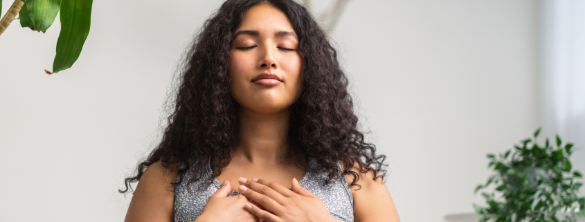 Woman using breathing techniques to control anxious breathing