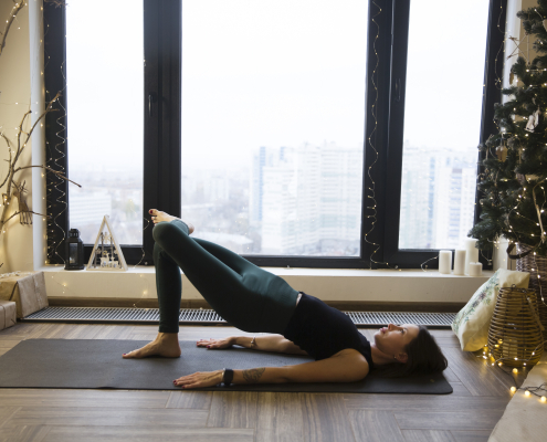 Woman doing yoga to look after her mental health at christmas