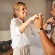 Older couple dancing in living room