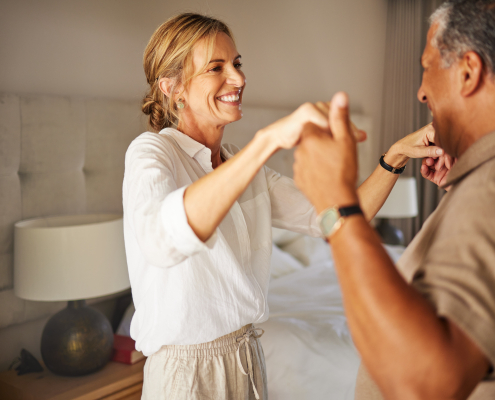 Older couple dancing in living room