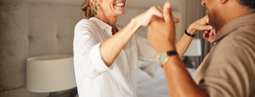 Older couple dancing in living room